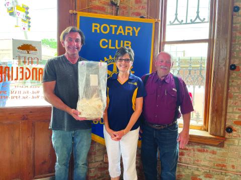 MUSHROOM GARDENING DISCUSSED - Mushroom farmer Phil Deshotel (left) holding an example of the mushrooms he grows) spoke about the gardening of mushrooms and the wide variety of mushrooms available to grow. He is shown with Rotary Treasurer Annette Johnson (center) and Rotarian Bob Manuel. (Gazette photo by Heather Bogard)