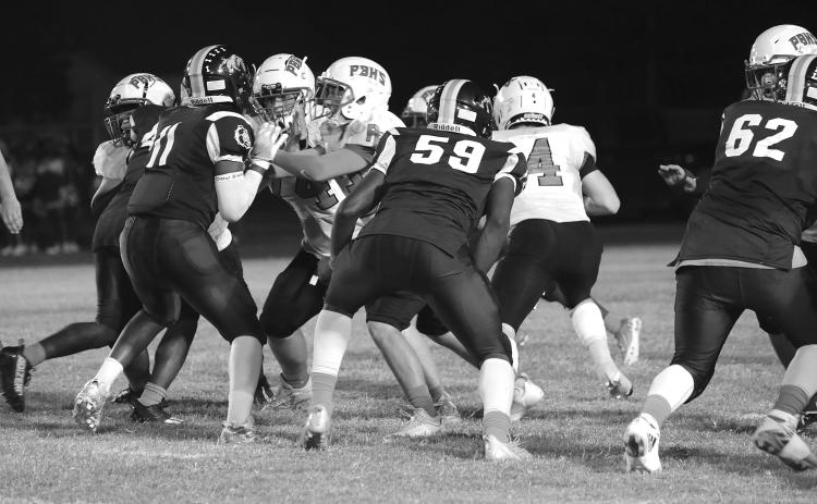 Members of the Ville Platte Bulldog defensive unit held Port Barre to 22 points last week helping the team record its second win of the season. The Bulldogs, tonight, head to Church Point. (Photo courtesy of Susan Angelle Photography)
