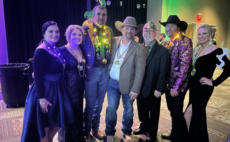Pictured from left in the left photo are Shallie Carson, Lelia Thrasher, Andy Carson, Derrick Thrasher, Mayor Lyle Nelson, of Bastrop, Texas, TJ Campbell, and Regina Pate while at the Taste of Mardi Gras Ball on Friday, February 2.