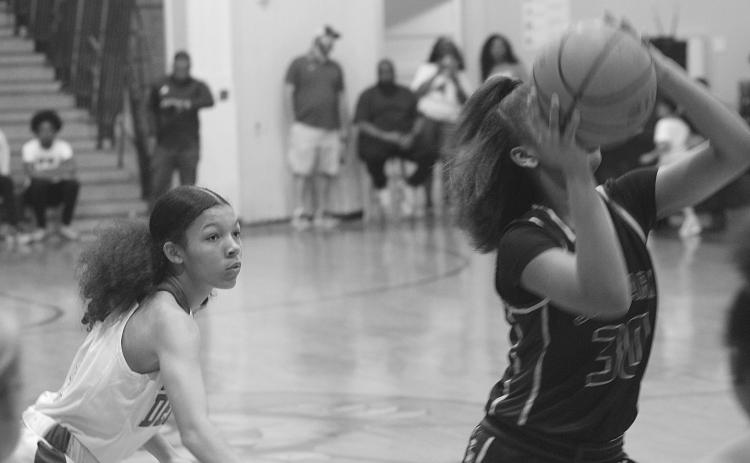Mamou’s Cadence Young (4) watches as J.S. Clark’s Shanna Simien (30) attempts a basket in the girls’ inaugural Evangeline Parish All-Star game. (Gazette photo by Rhett Manuel)
