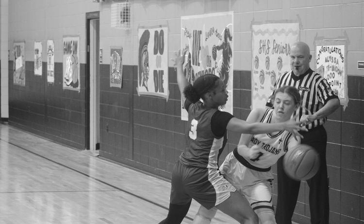 Averie Pitre (4) prevents the basketball from going out of bounds for the Lady Trojans in their win over Ascension Catholic. With the win, the team reached the quarterfinals for the second time in three years. (Gazette photo by Tony Marks)