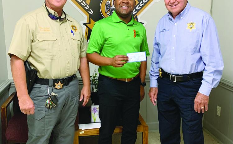 Pictured are Sheriff Charles Guillory (right) and Chief Deputy Scott Fontenot (left) as they receive a check from Lorenzo Richard (center), coalition coordinator, for $10,000.00 which has been applied toward the effort of raising awareness for underage drinking in the parish. (Photo courtesy of EPSO)