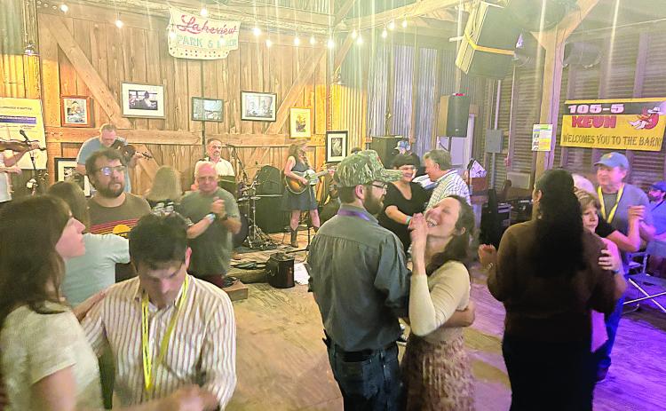 Participants and other guests dance to the band Balfa Toujours during the opening night of Dewey Balfa Cajun and Creole Heritage Week at Lakeview Park and Beach on Tuesday, March 25. Band member Christine Balfa is the daughter of Dewey Balfa. (Gazette photo by Tony Marks)