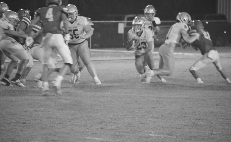 Kolton Lafleur (55) provides a block letting Jude Hebert (23) find some running room in Sacred Heart’s 17-14 win over Basile. (LSN photo by Rhett Manuel)