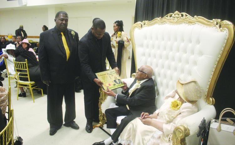On behalf of the Evangeline Parish Police Jury, Jurors Daniel Arvie (standing left) and Darion Arvie (standing right) present a proclamation to Pastor Eradly Ben Sr. (seated left) and First Lady Lois Ben (seated right) in recognition for their 50 years of ministry to Antioch Baptist Church. (Gazette photo by Tony Marks)