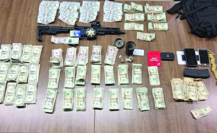 Pictured are the firearm, narcotics, and currency which were seized following the arrest of Brusly resident Calvin B. Jarvis. (Photo courtesy of EPSO)
