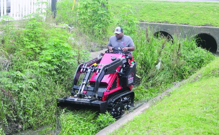 Ville Platte Mayor Ryan Leday Williams is pictured as he clears a portion of a canal located at the intersection of Tate Cove Road and E. Jefferson Street. (Gazette photo by Tony Marks)