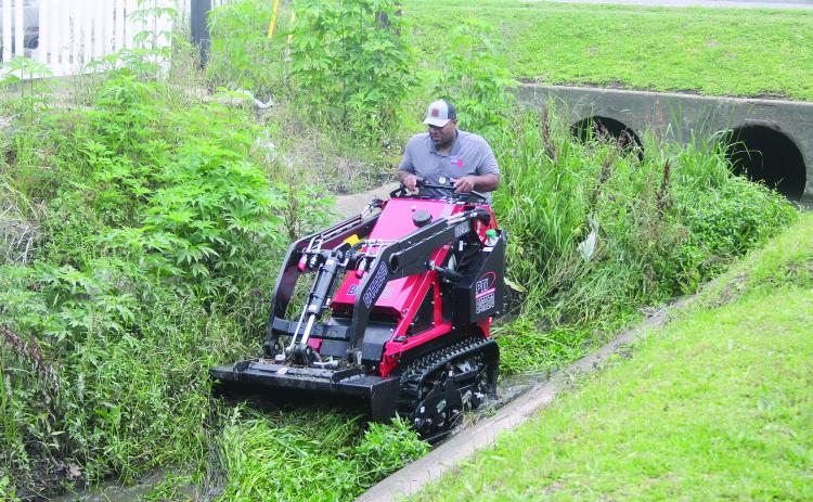 Ville Platte Mayor Ryan Leday Williams is pictured as he clears a portion of a canal located at the intersection of Tate Cove Road and E. Jefferson Street. (Gazette photo by Tony Marks)