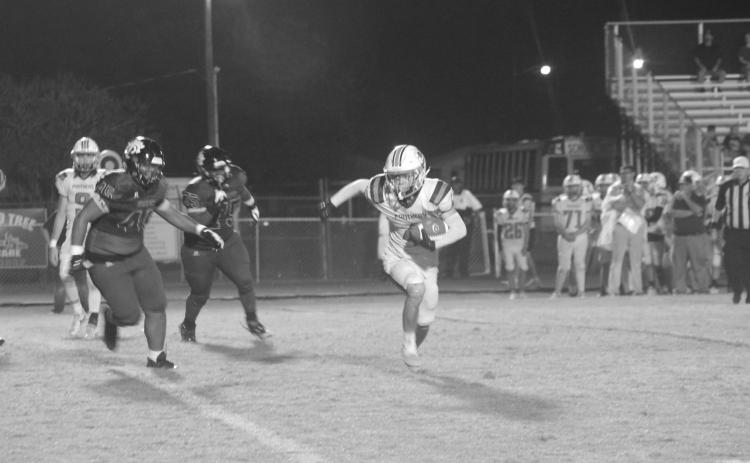 Cayden Fontenot (4) looks for daylight between him and a couple of Church Point defenders in Pine Prairie’s 54-14 loss in the district opener. (Gazette photo by Rhett Manuel)