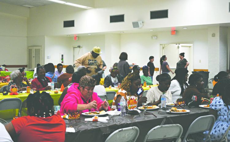 SPECIAL THANKSGIVING CELEBRATION HELD - The Second Annual Community Thanksgiving gathering and meal was held at the Northside Civic Center on Sunday, November 23. A large turn out enjoyed the delicious meal and fellowship. Pictured above, those in attendance dig into the homecooked meal prepared and sponsored by members of the community.