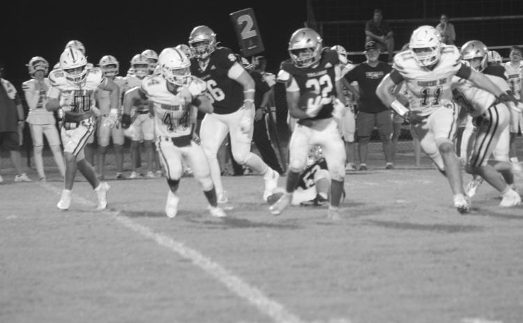 Gavin Patin (22) gains rushing yards for Sacred Heart in the Trojans’ 48-36 win over Metairie Park Country Day last week (Gazette photo by Tony Marks)