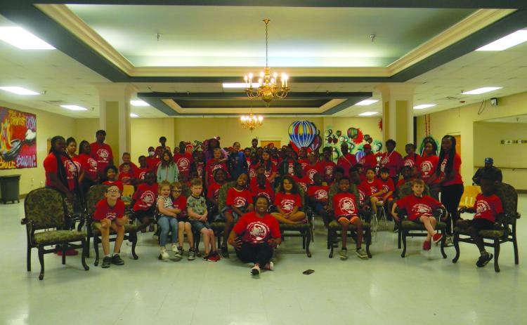 Astronaut in training Alyssa Carson and actor Eric Street pose with the students and staff of the Ville Platte Girls-Boys Place.