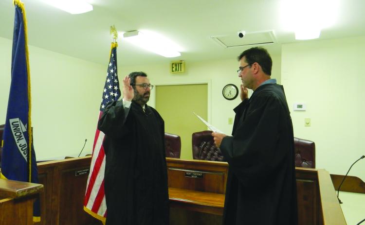 Jacob Fusilier (left) takes the oath of office as new magistrate for the Town of Mamou. Administering the oath is Fusilier’s predecessor Marcus Fontenot (right) who was elected as district judge in Division A for the 13th Judicial Court. For more photos, turn to Page 10. (Gazette photo by Heather Bogard)