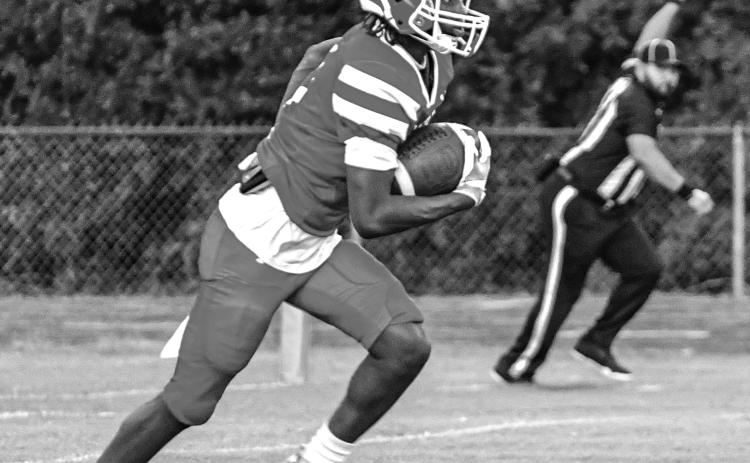 KICK-OFF RETURN - Marcus Evans takes the opening kickoff on his way to a 91-yard scoring gallop. (Photo by Tonya Ortego)