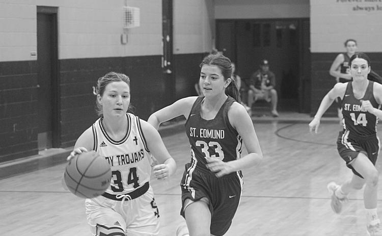 Taylor Darbonne (34) drives past a St. Edmund defender on her way to the goal in  Sacred Heart’s district clinching 30-23 win over the Lady Blue Jays on Tuesday night. (Gazette photo by Rhett Manuel)