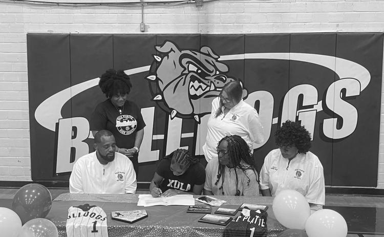 Destiny Lavigne (seated center left) is pictured as she signs to play college softball with Xavier University of Louisiana. Also pictured (from left) are standing Ville Platte High School Principal Shelsy Williams and former Ville Platte High School Assistant Principal Dawn Bellard; seated- Ville Platte High School Softball Coach Devinskie Arvie, Latoya Lavigne, and Ville Platte High School Assistant Coach Shonda Jack.