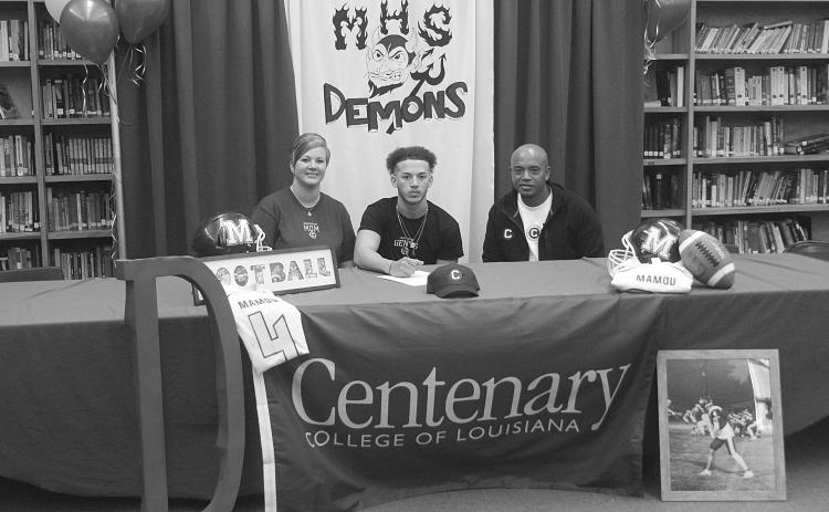 Devin Ardoin (center) is pictured as he signs to play college football at Centenary College of Louisiana in Shreveport. Also pictured are his mother, Natalie Ardoin, on the left, and his father, Sentell Ardoin, on the right. (Gazette photo by Tony Marks)