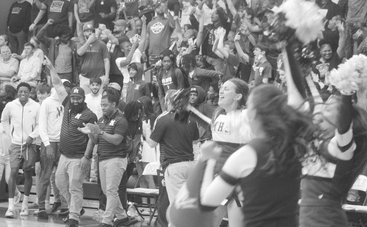 Members of the Mamou coaching staff and cheerleading squad, as well as other member of the Mamou community, celebrate after the Mamou Green Demons advanced to the state semifinals. With the win, the team moved on to play Marksville on Wednesday, March 11, at Burton Coliseum in Lake Charles. (Gazette photo by Tony Marks)