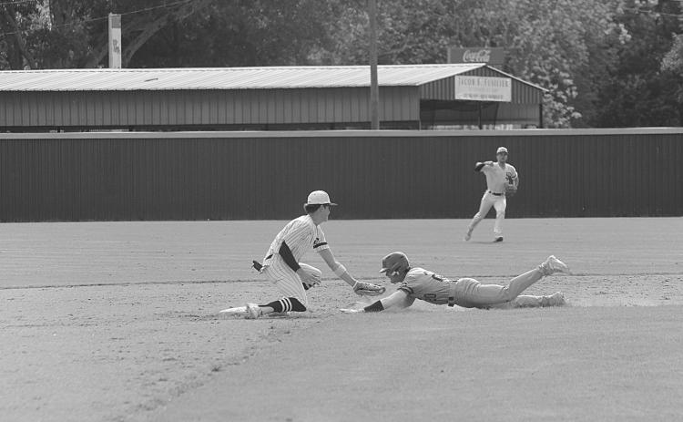 Rightfielder Wade Pitre (24) gives a celebratory fist bump as second baseman Hayden Droddy (9) retires a Catholic-Pointe Coupee runner on the base paths in Sacred Heart’s extra inning 4-2 loss on Monday, April 10. (Gazette photo by Rhett Manuel)