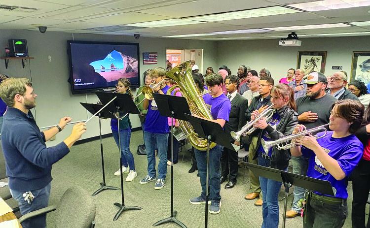 John Havard (left) conducts as members of the Pine Prairie High School Marching Band perform the National Anthem at the Evangeline Parish School Board meeting held Wednesday, November 20. From left are Kelly Monier, Camren Vidrine, Collin Vidrine, Adyson West, and Sarah Sullivan. (Gazette photo by Tony Marks)