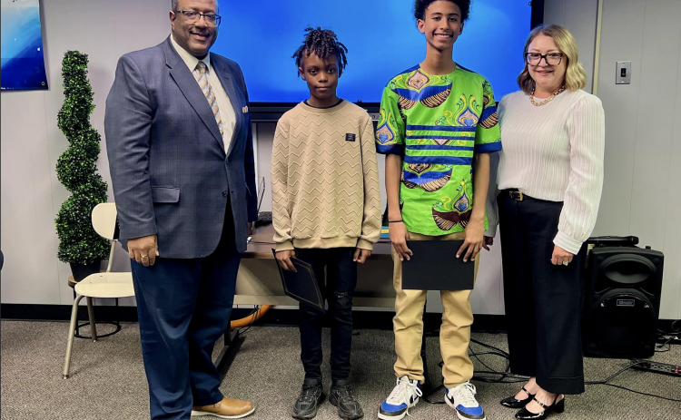 From left are Superintendent Darwan Lazard; Jaiden Thomas, 5th grade student of the year from James Stephens Montessori; Ethan Zang, 8th grade student of the year from Evangeline Reimagine Academy; and Supervisor Cheri Fontenot. Not present was Charlee Smith, 12th grade student of the year from Basile High School. (Gazette photo by Nancy Duplechain)