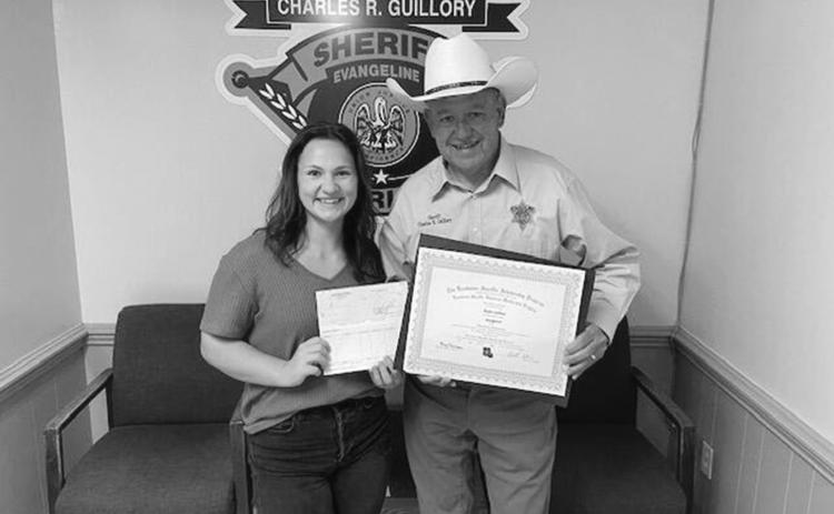 Ricki Lafleur (left) is pictured with Evangeline Parish Sheriff Charles Guillory after receiving an academic scholarship from the Louisiana Sheriff’s Scholarship Program. (Photo courtesy of EPSO)