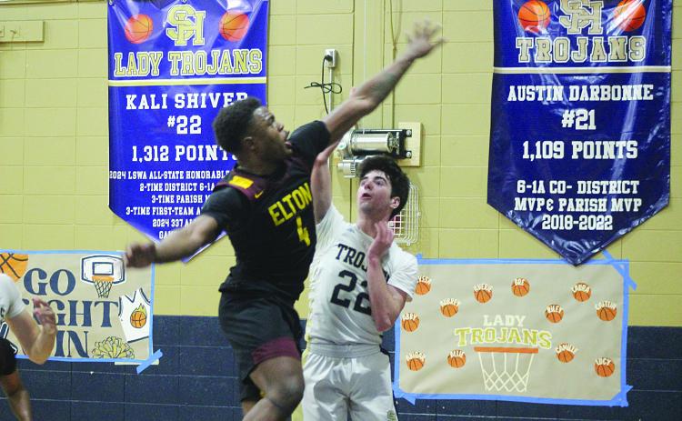 Nolan Johnson (22) manages to get off a shot from the court in Sacred Heart’s 44-36 win over Elton last Friday at home. (Gazette photo by Tony Marks)