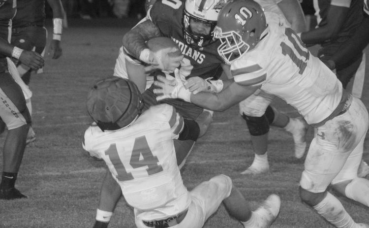 Pierson Comeaux (14) and Carter Darbonne (10) look to make a tackle against an Elton runner in Basile’s playoff loss last Friday. (LSN photo by Rhett Manuel)