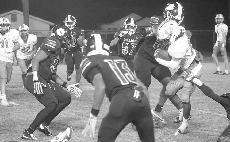 Members of the Ville Platte defensive unit, including Keith Doucet (55) attempt to make a stop against a Eunice ball carrier. (Gazette photo by Tony Marks