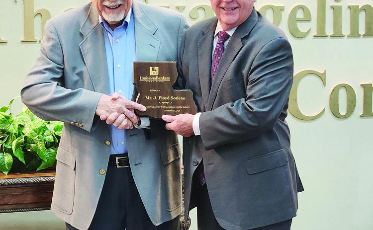 Floyd Soileau (left) is pictured as he receives a commemorative plaque for 54 years of service on The Evangeline Bank and Trust Company’s Board of Directors. He was presented the plaque by the bank’s President, Chief Executive Officer, and Chairman of the Board Randel Chapman during a ceremony held Friday, January 9. (Photo courtesy of The Evangeline Bank and Trust Company)