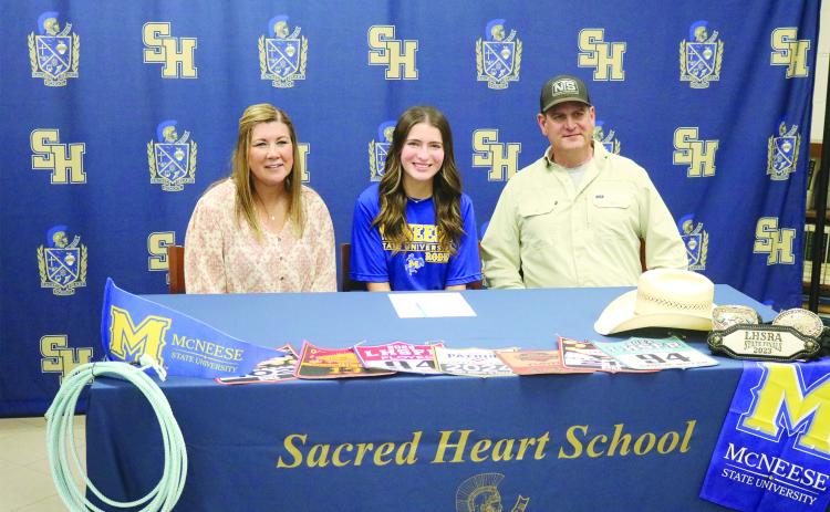 Mackenzie Floyed (center) is pictured with her mother, Ann; and father, Robert, during a signing ceremony on Monday, March 25, at Sacred Heart. (Gazette photo by Tony Marks)
