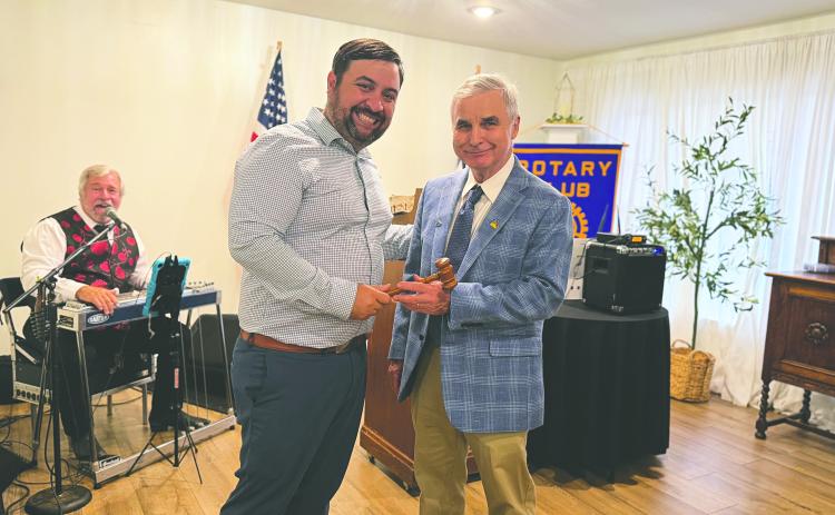 PASSING THE GAVEL - Outgoing president Beau Wilson (left) handed off the president’s meeting gavel to newly-installed president Dr. Kirk Soileau (right). (Gazette photos by Heather Bogard)