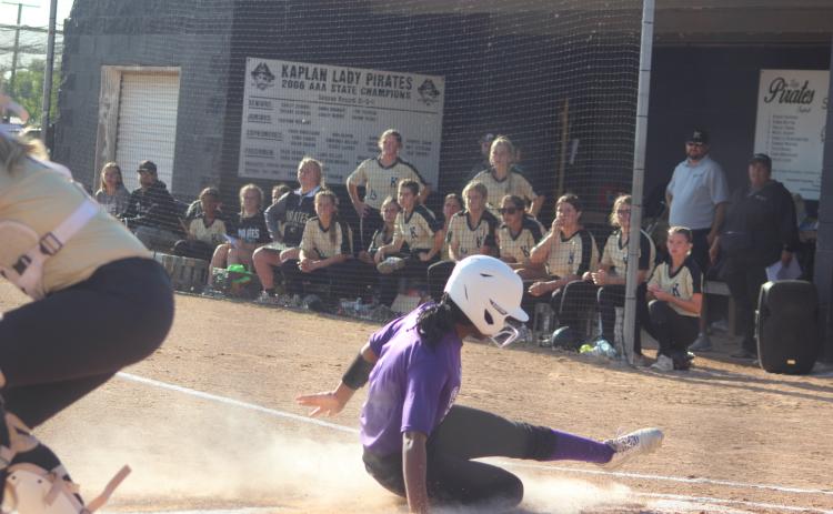 Destiny Lavigne (1) slides home for the only Ville Platte run in the Lady Bulldogs’ playoff loss to Kaplan Monday night. Lavigne, the lead off hitter and starting left fielder, went 1-for-2 at the plate to go with her run scored. (Gazette photo by Rhett Manuel)