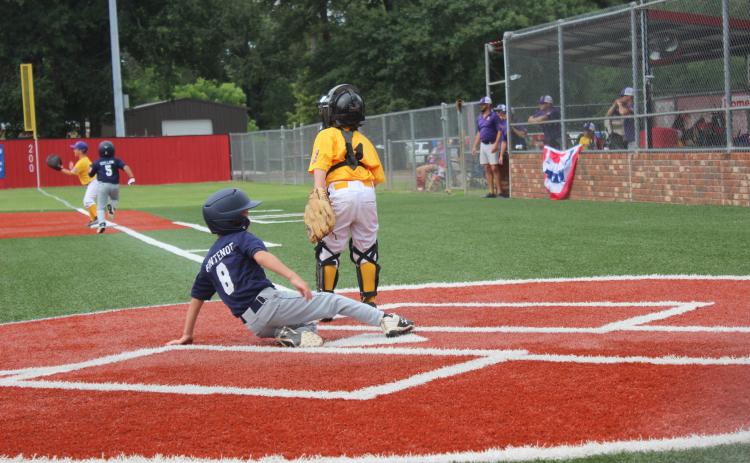 Ville Platte 7U Coach Pitch All-Star Jacques Fontenot slides into home plate to score a run in a 12-1 win over Benton in four innings last Thursday. The 7U All-Stars had a successful weekend, going 5-2 and finishing in third place in the state tournament to qualify for the World Series in Monroe. (Gazette photo by Rhett Manuel)