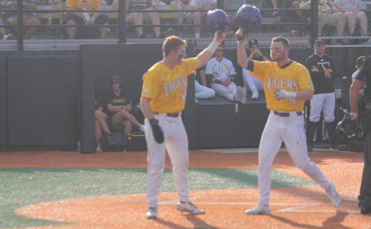 Cade Doughty  (4) gets a helmet salute from teammate Eric Berry (14) after both runners scored on Doughty’s two-run home run in the top of the first inning in LSU’s 8-4 loss to Southern Miss on Sunday, June 5. (Gazette photo by Tony Marks)