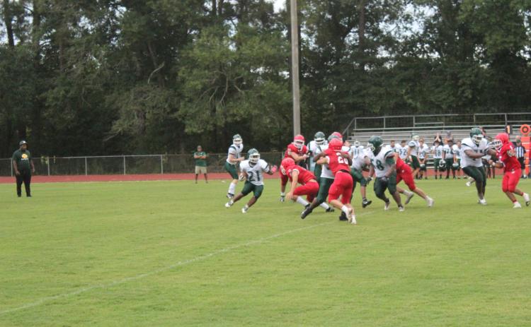 Mamou’s Keontez Campbell (21) tries to find a running lane against a stingy Basile defense in the teams’ scrimmage held Thursday, August 18. (Gazette photo by Rhett Manuel)