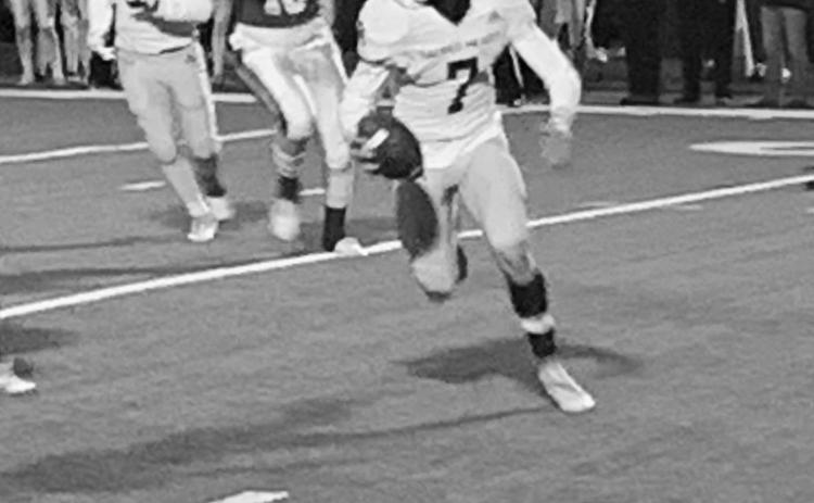 Hayden Droddy (7) scrambles as a play tries to develop for Sacred Heart in the Trojans’ playoff loss to Ouachita Christian Friday night. (Gazette photo by Rhett Manuel)