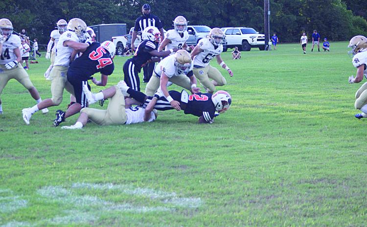 The Sacred Heart defense converges to make a stop against Pine Prairie in the Evangeline Parish Jamboree. The Trojans begin the season 1-0 after earning a win over Ville Platte High because of a forfeit. (Gazette photo by Rhett Manuel)