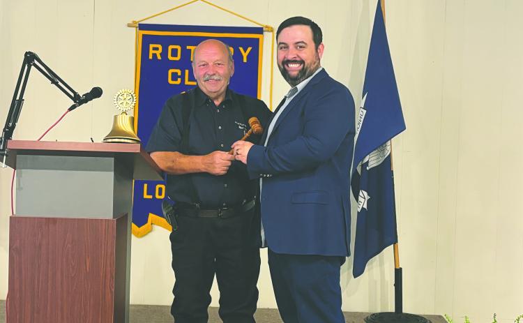 PASSING THE GAVEL - Outgoing president Bob Manuel (left) presented the president’s meeting gavel to newly-installed president Beau Wilson.