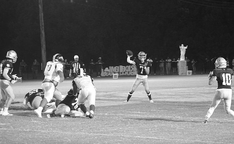 Trojan quarterback Hayden Droddy (7) delivers a pass to Blake Hebert (10) in Sacred Heart’s 44-0 win over Ville Platte High in the resumption of the Tee Cotton Bowl. Droddy completed 6 of 8 passes for 142 yards and three passing touchdowns. He also rushed for 116 yards and two touchdowns. (Gazette photo by Rhett Manuel)