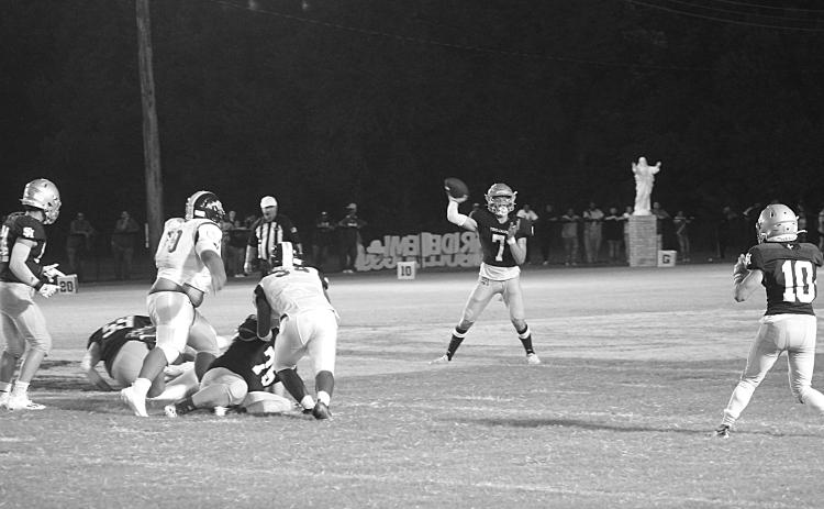 Trojan quarterback Hayden Droddy (7) delivers a pass to Blake Hebert (10) in Sacred Heart’s 44-0 win over Ville Platte High in the resumption of the Tee Cotton Bowl. Droddy completed 6 of 8 passes for 142 yards and three passing touchdowns. He also rushed for 116 yards and two touchdowns. (Gazette photo by Rhett Manuel)