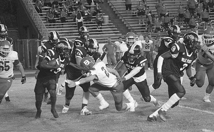Ville Platte’s Montagon Dixon (13) avoids a tackle from Basile’s Jackson Courville (2) in the Bulldogs’ 35-20 home loss to the Bearcats. (Gazette photo by Rhett Manuel)