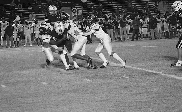 Several Ville Platte defensive players combine to make a stop against Pine Prairie in their matchup last week. The Bulldogs, now 1-1 in district play, travel to Mamou to battle the Green Demons, who are also 1-1 in district. (Gazette photo by Rhett Manuel)