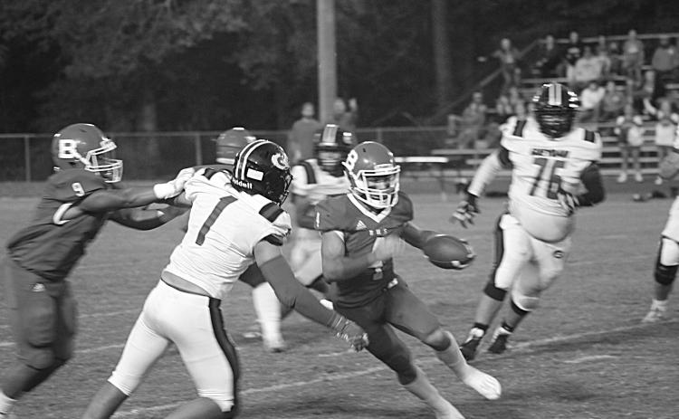 Basile quarterback Luc Johnson (4) scrambles for yardage against the Gueydan defense in Friday night’s 27-0  district win at home. (Gazette photo by Rhett Manuel)