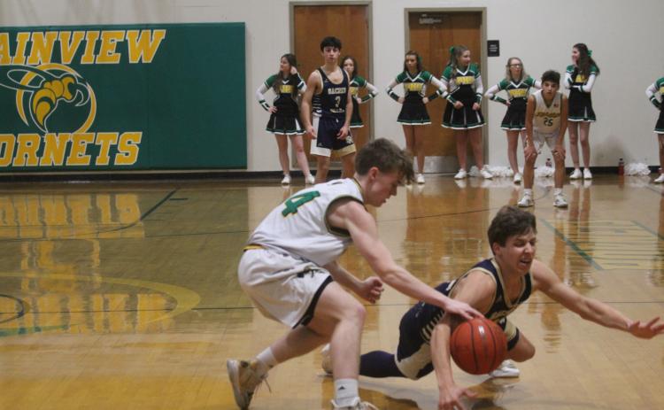 Austin Darbonne (21) goes after a loose basketball as his Sacred Heart Trojans take on the Hustlin Hornets of Plainview. Darbonne scored 11 of his 19 points in the fourth quarter as his team earned a 76-44 win. (LSN photo by Tony Marks)