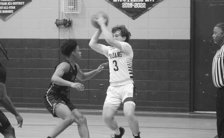 Gabe Fontenot (3) looks to pass the basketball to a Sacred Heart teammate while being defended by a J.S. Clark player. (Gazette photo by Tony Marks)