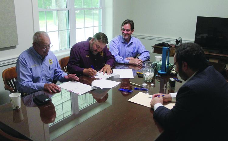 Evangeline Parish Police Jury President Bryan Vidrine (second from left) signs the cooperative endeavor agreement among the Evangeline Parish Law Enforcement District, Evangeline Parish Sheriff, and police jury for the construction of a new 200-bed jail in the Industrial Park at an estimated cost of $18 million. Also pictured are Sheriff Charles Guillory (left), Police Jury Secretary-Treasurer Donald Bergeron (center) and Parish Attorney Jacob Fusilier (right).
