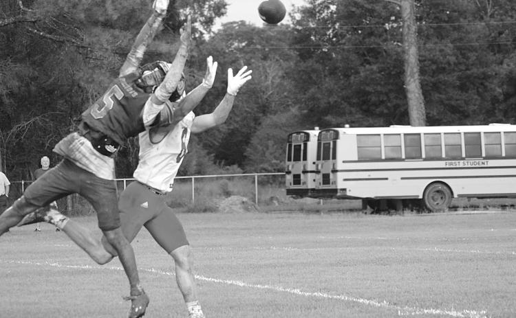 Ville Platte High’s Greg Guillory (5) breaks up a pass intended for Basile’s Parker Fontenot (6) in the Bulldogs’ 6-0 in the Evangeline Parish Jamboree at Pine Prairie Friday night. (Gazette photo by Sylis Manuel)