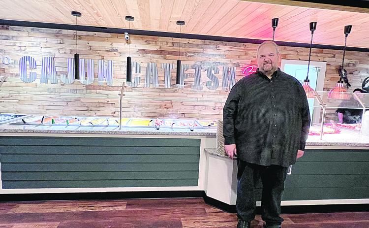 John Deville is pictured as he stands in a newly renovated Cajun Catfish Buffet, which recently celebrated its 10th anniversary. (Gazette photo by Nancy Duplechain)
