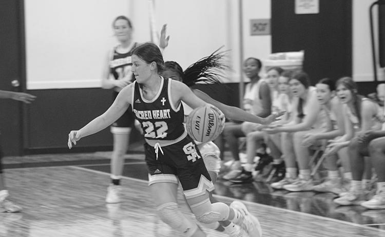 Sacred Heart’s Kali Shiver (22) moves toward the net in the Lady Trojans’ season ending loss to Delta Charter Monday night. Shiver was the leading scorer with 13 points. (Gazette photo by Rhett Manuel)